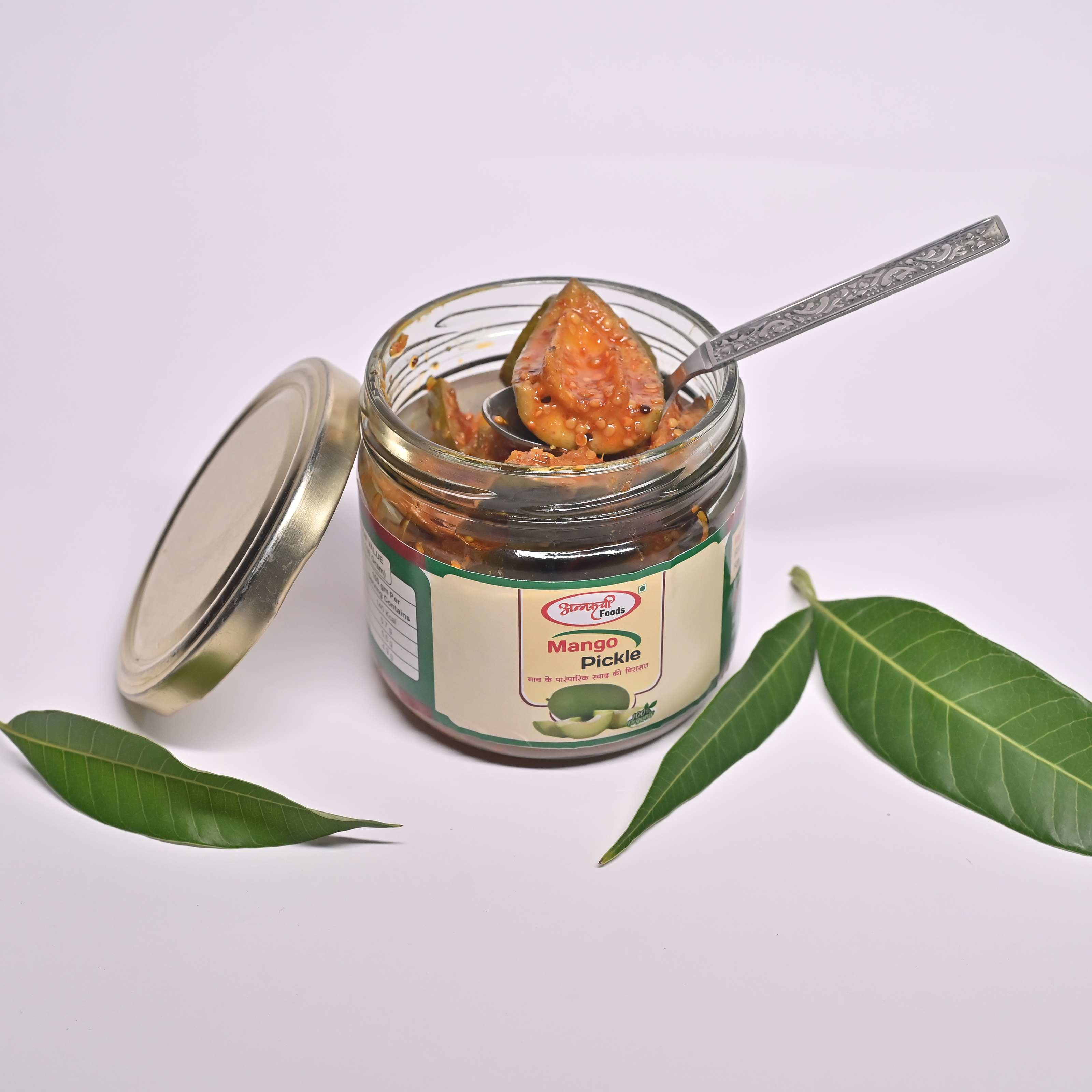 Thumbnail: Glass jar of Lemon Chilly Pickle with black lid surrounded by rustic dark background